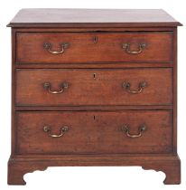 A George III oak chest of drawers, circa 1765; the top with moulded edges above three long drawers,