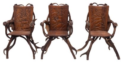 A suite of carved oak and antler furniture,