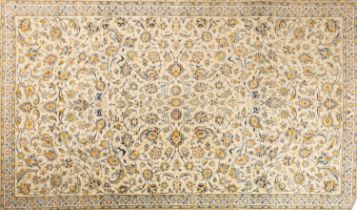 A Kashan carpet, the pistachio field with an all over Shah Abbas design of scrolling palmettes,