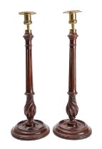 A pair of mahogany and brass mounted candlesticks in George III style,