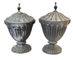 A pair of late George III lead urns and covers, early 19th century; in Neoclassical style,