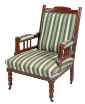 A late Victorian mahogany and upholstered open armchair,