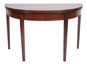 A Regency mahogany circular dining table, converting to a demi-lune side table,
