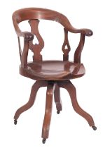 An Edwardian mahogany swivel desk chair,