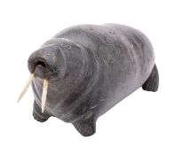 An Inuit sculpted stone model of a walrus, 20th century; with inset bone tusks; 14cm high,