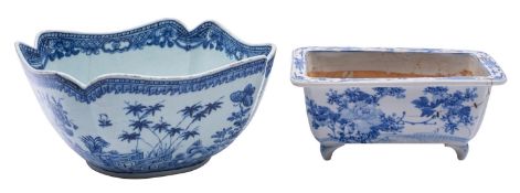 A Chinese porcelain bowl of lobed form with notched rim painted in blue with a garden landscape,