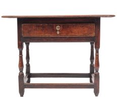 A 17th-century oak rectangular side table; an overhanging moulded top above a drawer,