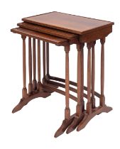 A nest of three mahogany and line inlaid occasional tables in Regency taste,