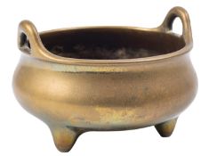 A Chinese polished bronze tripod censer and three small hardstone carvings the censer of compressed
