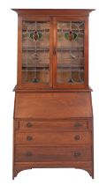 A mahogany and stained glass bureau bookcase in Arts & Crafts taste,