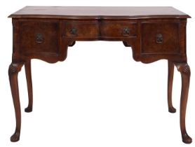 An Edwardian walnut serpentine front dressing table, in George II style,