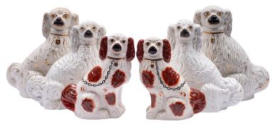 Three pairs of Staffordshire comforter spaniels, in seated posture with gilt collars and chains,