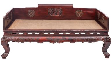 A Chinese carved and stained hardwood and rattan day bed,