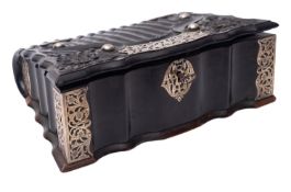 A Ceylonese carved Macassar ebony and white metal mounted box in the form of a volume,