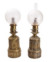 A matched pair of gilt repoussé brass table oil lamps, in Gothic taste,