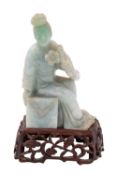 A Chinese carved jadeite figure of an Immortal seated holding a flower spray, 20th century,