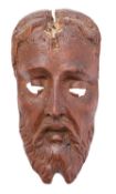 A carved and stained walnut mask, probably Spanish,