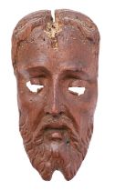 A carved and stained walnut mask, probably Spanish,