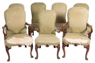 A set of seven George II walnut and upholstered dining chairs,