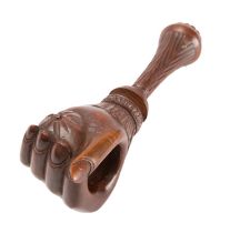 A Victorian carved walnut nutcracker in the form of a clenched lady's hand,