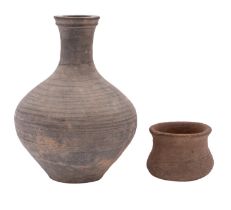 A Chinese Neolithic grey pottery vessel and one smaller the first with black painted horizontal