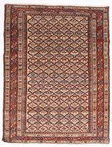 An Indo Persian rug, the ivory lattice field with geometric motifs,