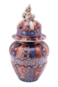 A Japanese Imari jar, of moulded oviform the domed cover with Shi-shi knop,
