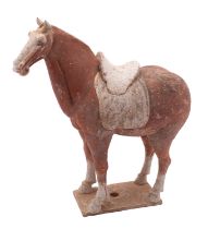 A Chinese painted pottery horse in Tang style standing four-square on plain rectangular base,