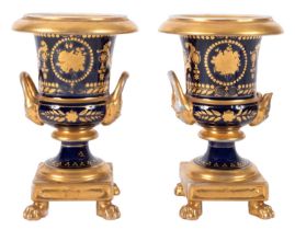 A pair of Continental porcelain urns, of campana form on square bases with lion paw supports,