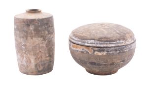 A Chinese Neolithic grey pottery bowl and cover and a similar jar both painted with scrollwork,