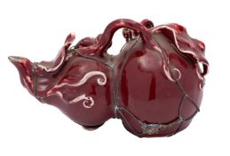 A Chinese copper-red teapot in the form of a gourd with metal banding,