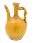 A Turkish Canakkale ochre-glazed water ewer with long curved spout and braided handle, 19th century,