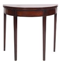 A George III mahogany and crossbanded demi-lune tea table,