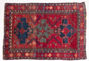 A Kasak rug, the wine field with triple indigo and pastel blue stepped cruciform medallions,