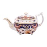 A Derby porcelain teapot, of oval form set on bun feet and decorated in the Imari pattern,