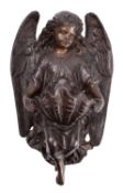 A patinated metal stoup in the form of an angel,