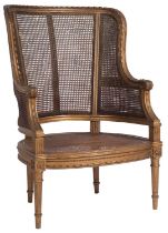 A carved giltwood and canework bergere armchair in Louis XVI taste,