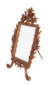 A 'Black Forest' carved and stained wood dressing table mirror,