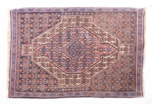 A Hamadan rug, the field with a central rose pointed panel,