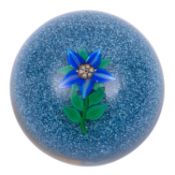A Paul Ysart, Harland period paperweight, set with a single Clematis bloom on a jasper ground,