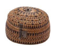 An East Indies oval basket work box and hinged cover decorated with geometric bands,