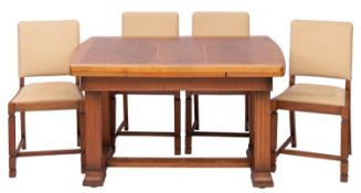 An oak draw leaf dining table and four chairs en suite,