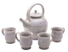 A stoneware teapot and four cups, attributed to John Lomas,