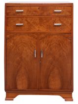 An English Art Deco figured walnut bedroom cabinet,