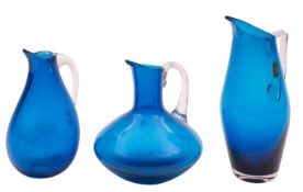 Three Whitefriars glass sparrow beak ewers, in kingfisher blue with tooled clear glass handles,