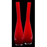 A pair of Murano cased glass vases, the red over white body of slender asymmetric form, 48cm high.
