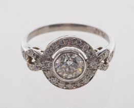A platinum ring set with a central diamond estimated at 0.