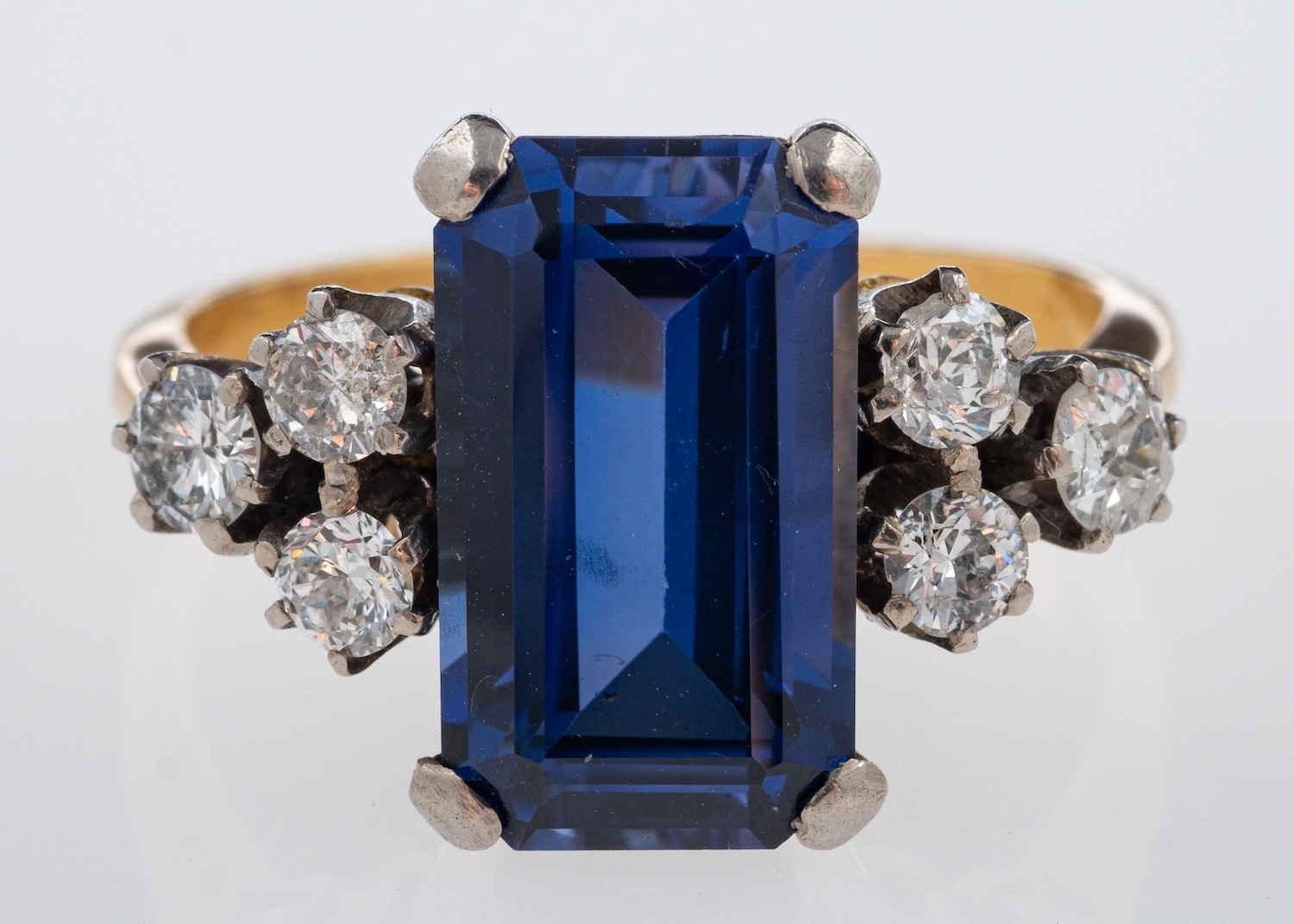 A cocktail ring set with diamond and synthetic sapphire, marks for 18ct gold, diamond,