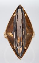 A 1970's dress ring of angular form set with a smoky quartz, ring head size, 3.