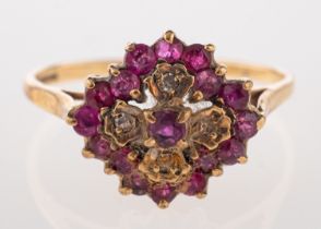 A 9ct gold, ruby and diamond cluster ring, set with circular cut rubies and eight cut diamonds,